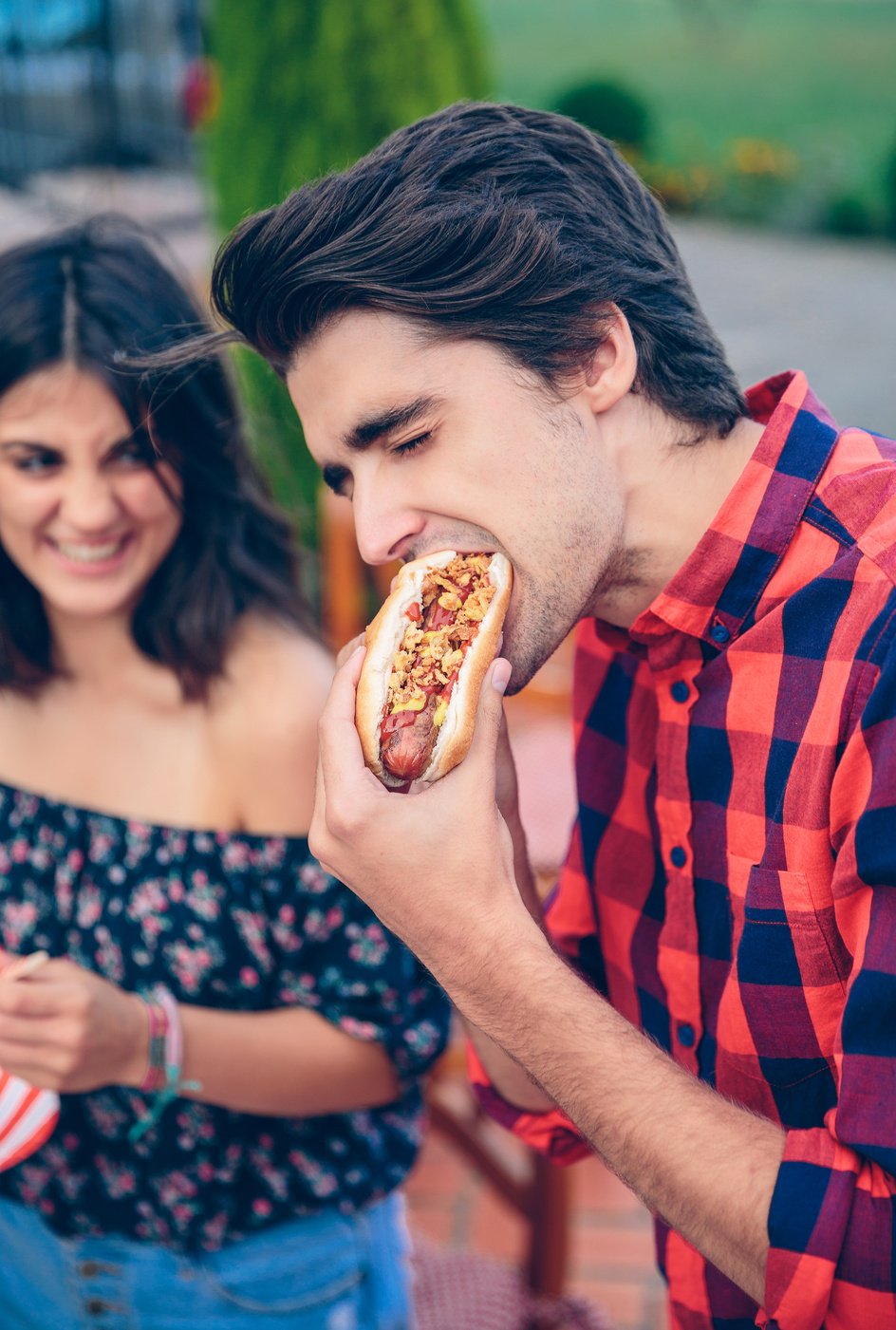 Young Man Eating Hot Dog 